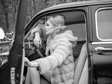 Call girl in vintage car. Travel and business trip or hitch hiking. Escort and security guard for luxury woman. sexy woman in fur coat. Retro collection car and auto repair by driver.