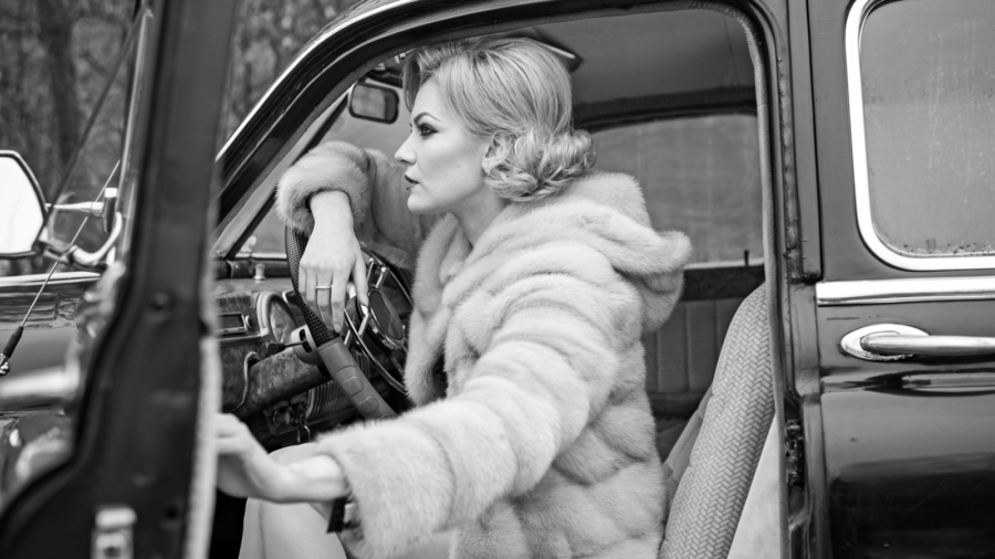 Call girl in vintage car. Travel and business trip or hitch hiking. Escort and security guard for luxury woman. sexy woman in fur coat. Retro collection car and auto repair by driver.